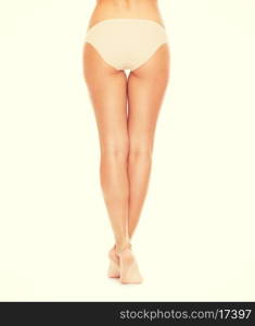 health and beauty concept - woman with long legs in cotton underwear