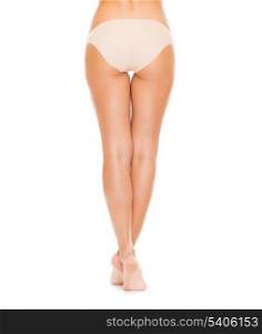 health and beauty concept - woman with long legs in cotton underwear