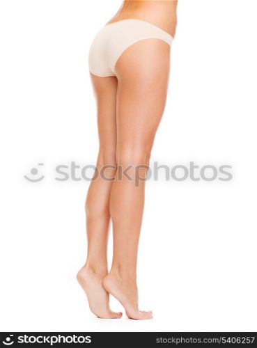 health and beauty concept - woman with long legs in cotton underwear