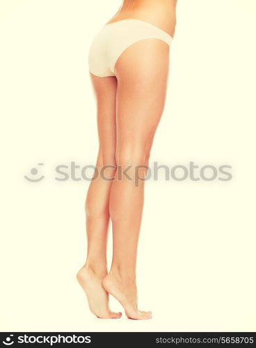 health and beauty concept - woman with long legs in cotton underwear