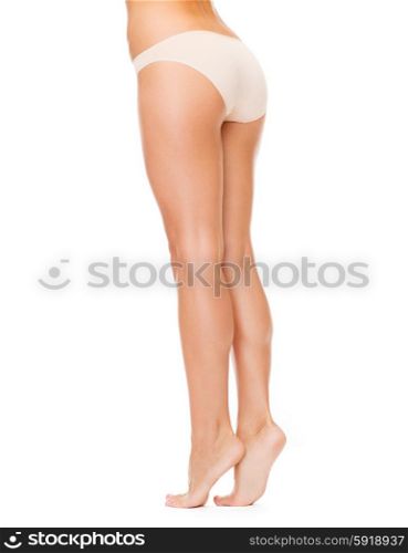 health and beauty concept - woman with long legs in cotton underwear. woman with long legs in cotton underwear