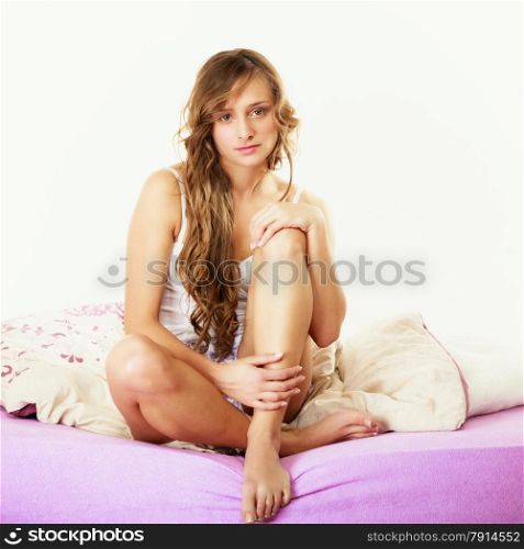 Health and beauty concept. Young lovely blonde woman long curly hair relaxing on her bed at morning