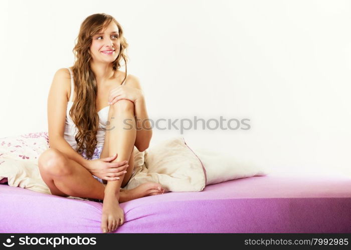 Health and beauty concept. Young lovely blonde woman long curly hair relaxing on her bed at morning