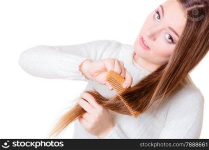 Health and beauty concept - young woman with long hair and wooden comb isolated