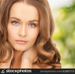 health and beauty, eco, bio, nature concept - face and hands of beautiful woman with long hair over green background