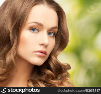 health and beauty, eco, bio, nature concept - face of beautiful woman with long hair over green background