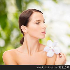 health and beauty, eco, bio, nature concept - relaxed woman with orhid flower