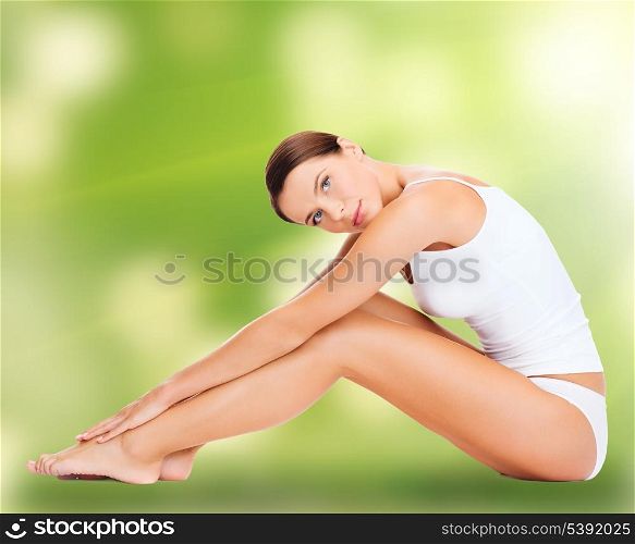 health and beauty, eco, bio, nature concept - sporty woman in cotton underwear doing exercises