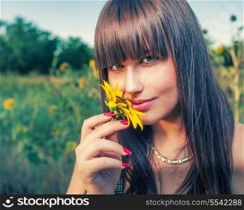 Health and beauty from mother Nature. Women smelling sunflower