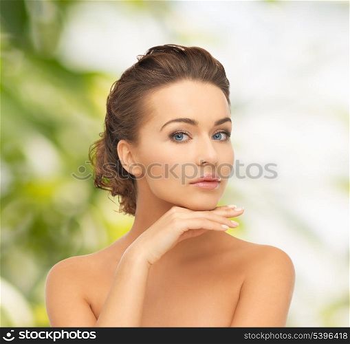 health and beauty, green, eco, bio concept - face and hands of beautiful woman with updo (can be used as a template for jewelry)