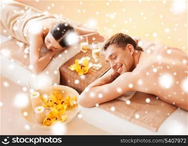 health and beauty, honeymoon and vacation concept - couple in spa salon lying on the massage desks