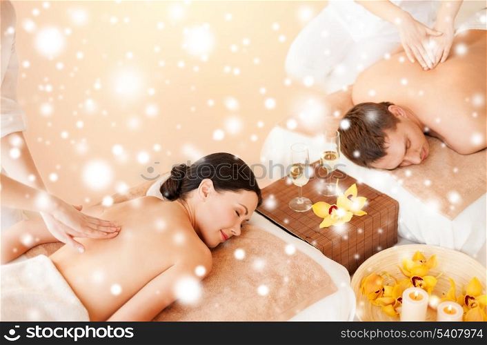 health and beauty, honeymoon and vacation concept -couple in spa salon getting massage