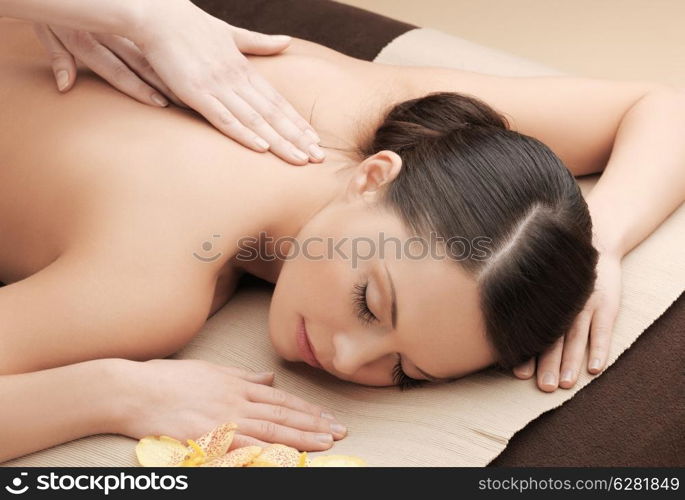 health and beauty, resort and relaxation concept - asian woman in spa salon getting massage