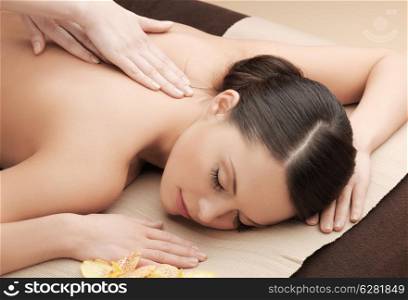 health and beauty, resort and relaxation concept - asian woman in spa salon getting massage