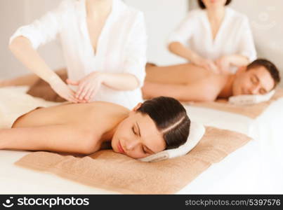 health and beauty, resort and relaxation concept - couple in spa salon getting massage