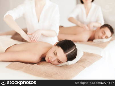 health and beauty, resort and relaxation concept - couple in spa salon getting massage