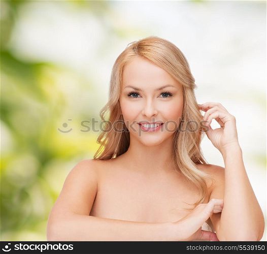health and beuty concept - beautiful woman playing with long hair