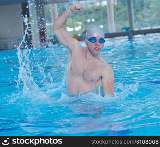 health and fitness lifestyle concept with young athlete swimmer recreating on indoor olimpic pool