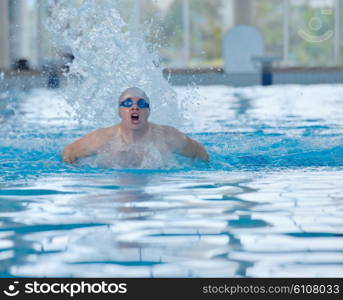 health and fitness lifestyle concept with young athlete swimmer recreating on indoor olimpic pool