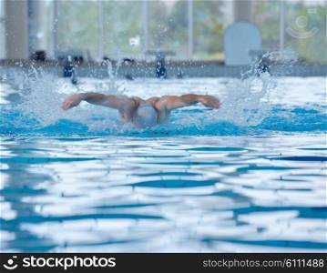health and fitness lifestyle concept with young athlete swimmer recreating on indoor olimpic pool