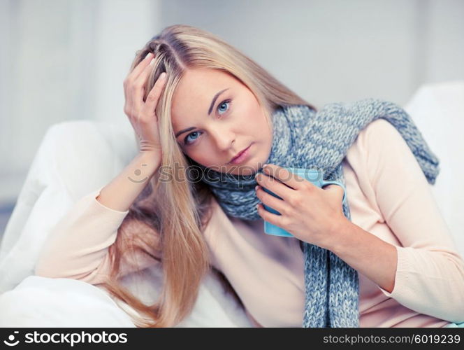 health and illness concept - indoor picture of diseased woman with cup of tea. diseased woman with cup of tea