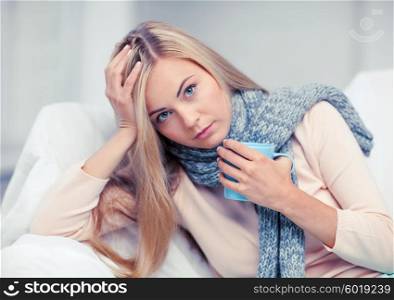 health and illness concept - indoor picture of diseased woman with cup of tea. diseased woman with cup of tea