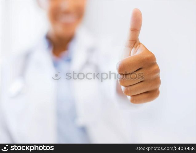 health and medicine concept - close up of female doctor hand showing thumbs up