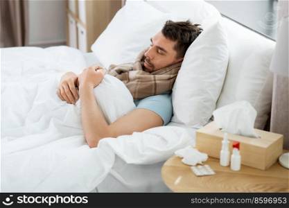 health and people concept - sick man sleeping in bed at home. sick man sleeping in bed at home