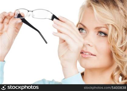 health and vision concept - close up of beautiful young woman wearing eyeglasses