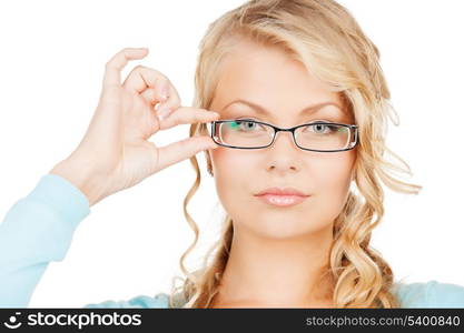 health and vision concept - close up of beautiful young woman wearing eyeglasses