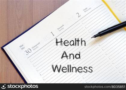 Health and wellness text concept write on notebook
