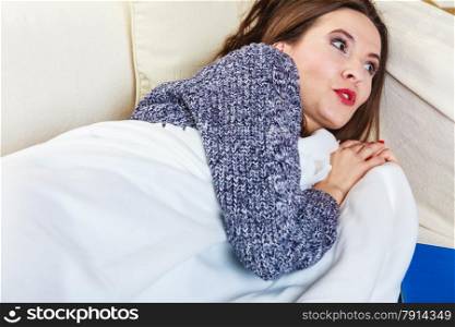 Health balance sleep deprivation concept. Sleeping woman on sofa. Girl lying on couch with book relaxed or taking power nap after lunch.