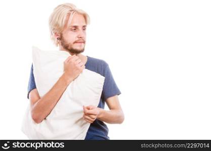 Health balance sleep deprivation concept. Sleepy tired guy holding pillow almost falling asleep. Health balance sleep deprivation concept. Male student or worker with lack of slumber, isolated on white. Sleepy young man holding white pillow