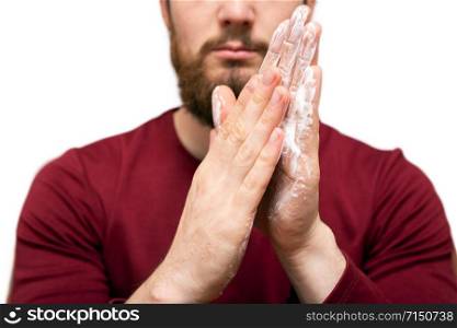 Health beauty and skin care concept. Closeup young bearded man with beard soap or shampoo on his hand for washing beard, cleaning concept Close-up with red t-shirt. Health beauty and skin care concept. Closeup young bearded man with beard soap or shampoo on his hand for washing beard, cleaning concept