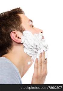 Health beauty and skin care concept. Closeup young bearded man with foam on face preparing to shave, guy shaving on white