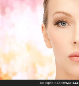 health, beauty and spa concept - close up of face of beautiful young woman