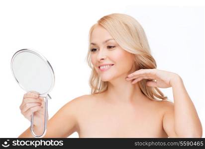 health, beauty and spa - smiling woman looking at mirror