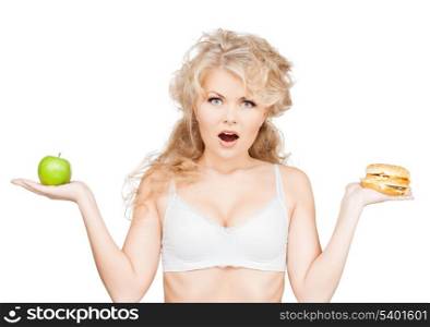health, beauty, weightloss, food, diet concept - sporty woman with apple and hamburger