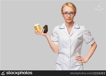 Health care and diet concept - doctor nutritionist or cardiologist holding fish oil in capsules for vitamin D and omega-3 fatty acids and avocado.. Health care and diet concept - doctor nutritionist or cardiologist holding fish oil in capsules for vitamin D and omega-3 fatty acids and avocado