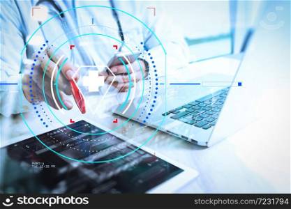 Health care and medical services with circular AR diagram.Medical technology concept. Doctor hand working with modern digital tablet and laptop computer with medical chart interface