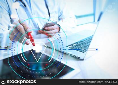 Health care and medical services with circular AR diagram.Medical technology concept. Doctor hand working with modern digital tablet and laptop computer with medical chart interface.