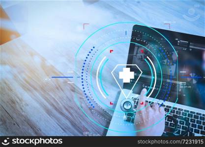 Health care and medical services with circular AR diagram.Medical technology concept. Doctor hand working with stethoscope and laptop computer