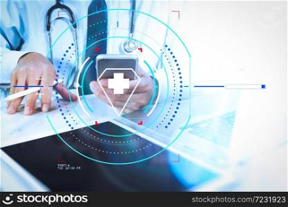 Health care and medical services with circular AR diagram.Medical technology concept. Doctor hand working with modern digital tablet and laptop computer with medical chart interface.