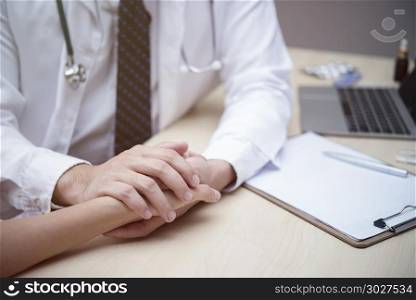 Health care concept. Doctor holding hand of patient to talking a. Health care concept. Doctor holding hand of patient to talking and encourage in hospital or clinic. Picture for add text message. Backdrop for design art work.