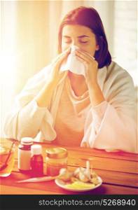 health care, flu, hygiene, age and people concept - sick woman with medicine blowing nose to paper wipe at home. sick woman with medicine blowing nose to wipe