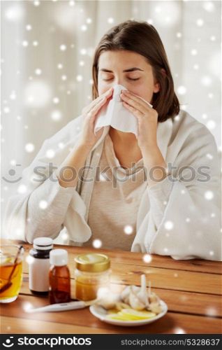 health care, flu, hygiene, age and people concept - sick woman with medicine blowing nose to paper wipe at home over snow. sick woman with medicine blowing nose to wipe