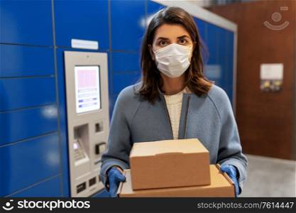 health care, mail delivery and pandemic concept - woman wearing face protective medical mask for protection from virus disease with boxes at automated parcel machine. woman in mask with boxes at parcel machine