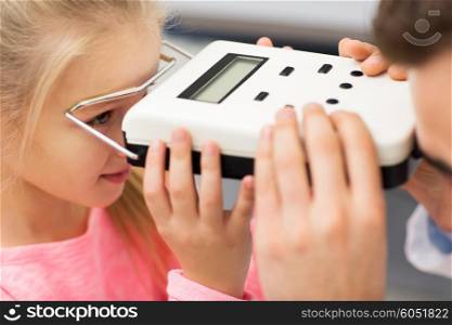 health care, medicine, people, eyesight and technology concept - close up of optometrist with pupillometer checking patient intraocular pressure at eye clinic or optics store