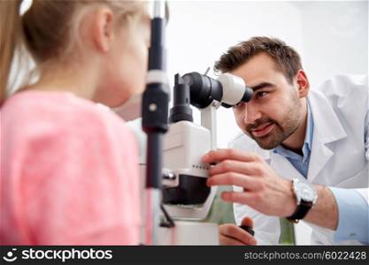 health care, medicine, people, eyesight and technology concept - optometrist with non contact tonometer checking patient intraocular pressure at eye clinic or optics store