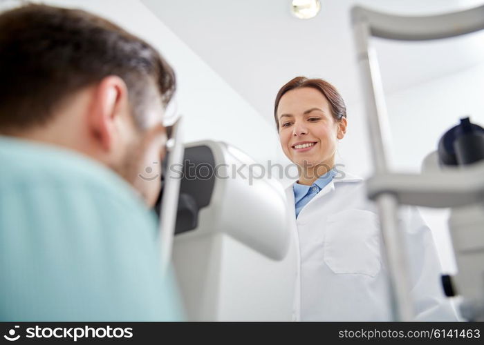 health care, medicine, people, eyesight and technology concept - optometrist with non contact tonometer checking patient intraocular pressure at eye clinic or optics store